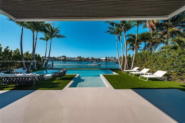 315 N Shore Dr, Miami Beach, FL 33141 - view of swimming pool featuring a water view, a patio, and a lawn
