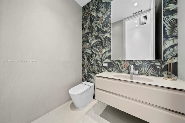 315 N Shore Dr, Miami Beach, FL 33141 - half bathroom featuring vanity, wallpapered walls, and toilet