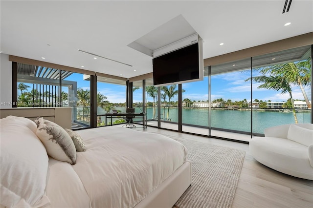 315 N Shore Dr, Miami Beach, FL 33141 - bedroom with visible vents, a wall of windows, recessed lighting, access to exterior, and wood finished floors