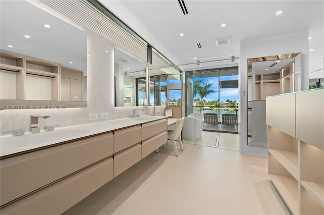 315 N Shore Dr, Miami Beach, FL 33141 - full bath with double vanity, a sink, visible vents, and a water view