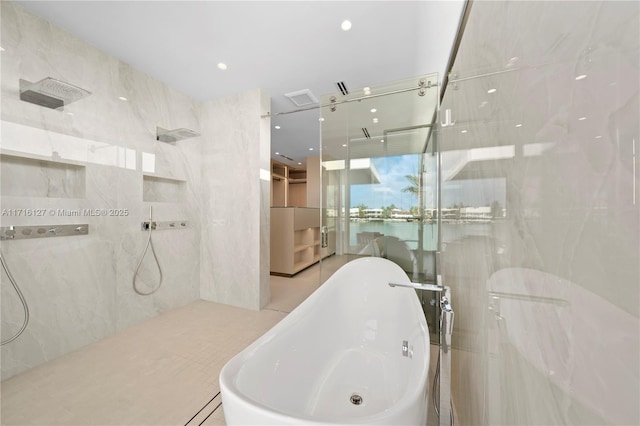 315 N Shore Dr, Miami Beach, FL 33141 - bathroom featuring a marble finish shower and a freestanding tub