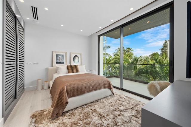 315 N Shore Dr, Miami Beach, FL 33141 - bedroom with access to outside, light wood-type flooring, recessed lighting, visible vents, and a wall of windows