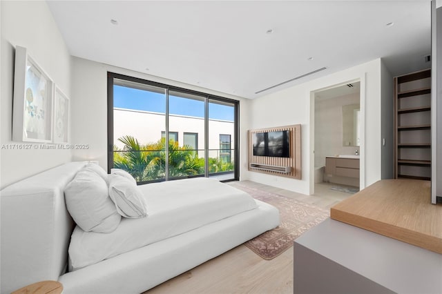 315 N Shore Dr, Miami Beach, FL 33141 - bedroom featuring light wood-type flooring and connected bathroom