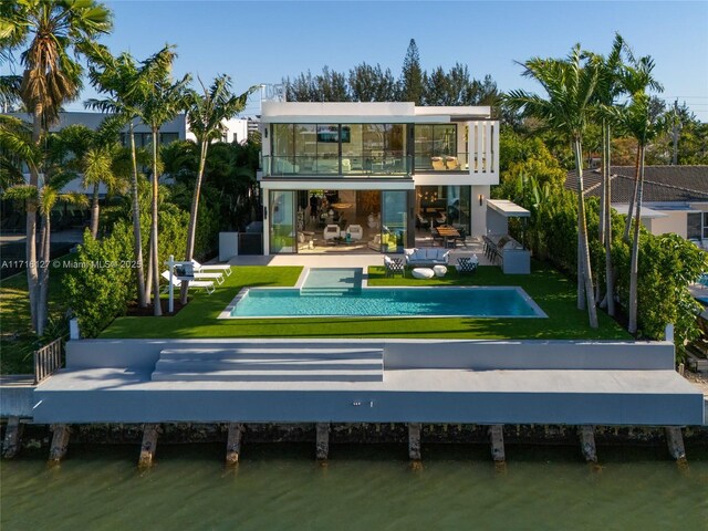 315 N Shore Dr, Miami Beach, FL 33141 - rear view of house with a yard, a patio area, a water view, and a balcony