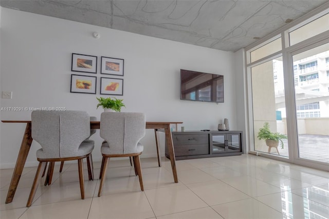 dining area featuring floor to ceiling windows and light tile patterned floors