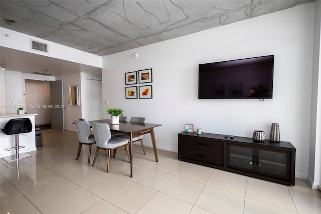 dining area featuring light tile patterned flooring