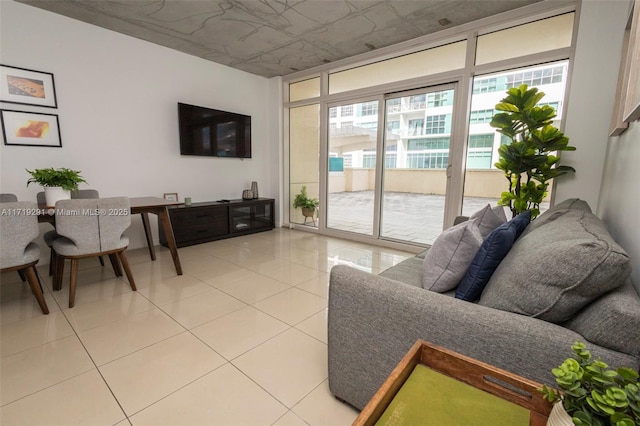 living room featuring light tile patterned floors and a wall of windows