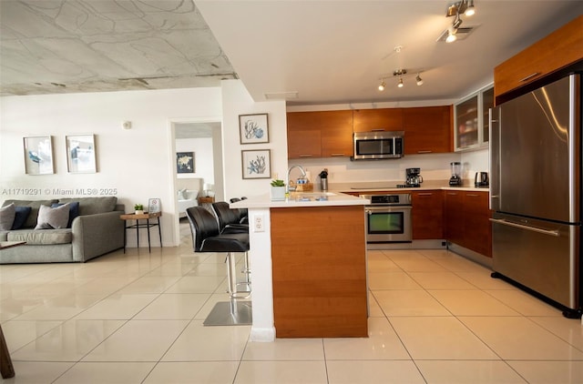 kitchen featuring light tile patterned flooring and stainless steel appliances