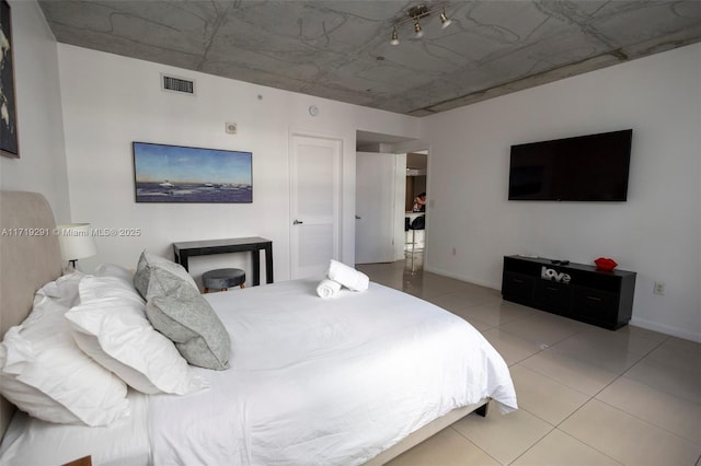 bedroom with light tile patterned floors