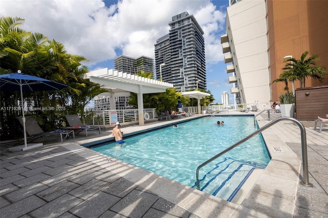 view of swimming pool with a patio area and a pergola