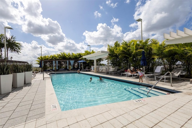 view of swimming pool featuring a patio area and a pergola