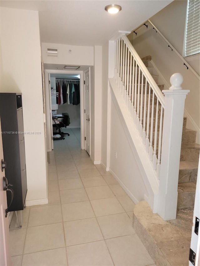 hall with light tile patterned flooring