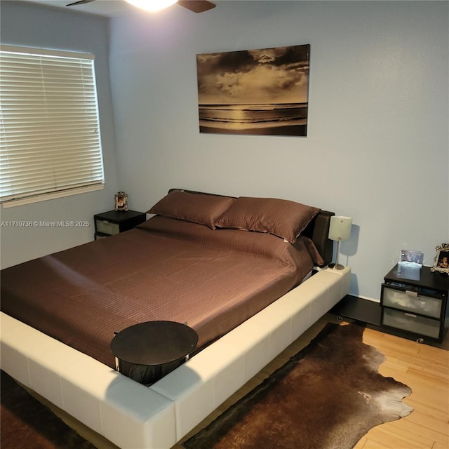 bedroom featuring ceiling fan and wood-type flooring