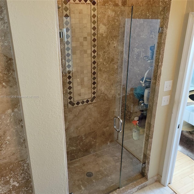 bathroom with a shower with door