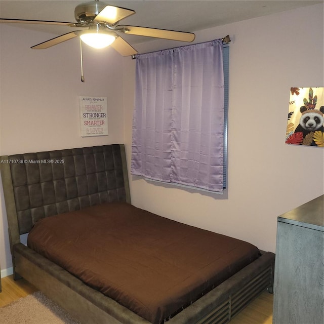 bedroom with light hardwood / wood-style flooring and ceiling fan