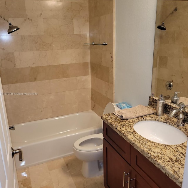 full bathroom featuring tiled shower / bath combo, toilet, and vanity