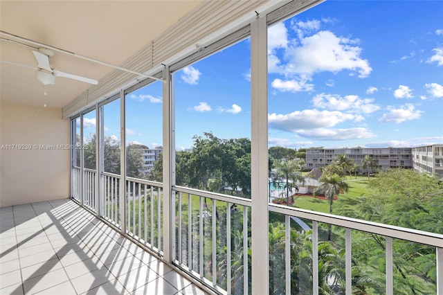 unfurnished sunroom with ceiling fan