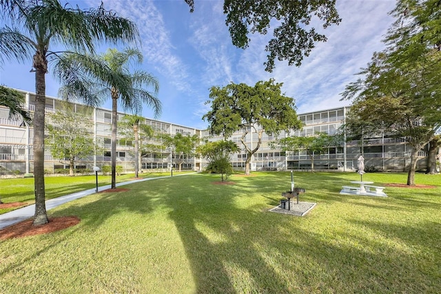 view of home's community featuring a lawn