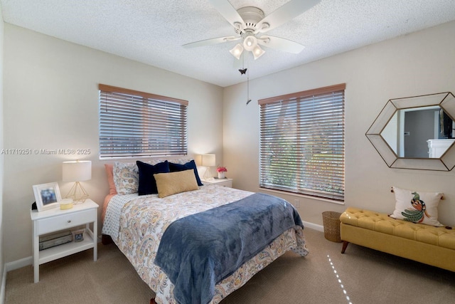 bedroom featuring ceiling fan, carpet floors, and a textured ceiling