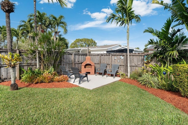 view of yard featuring a patio area and a fireplace