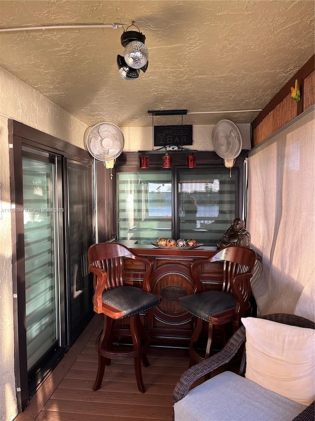 interior space with hardwood / wood-style floors and a textured ceiling