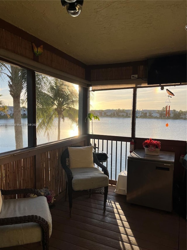 sunroom with a water view and a healthy amount of sunlight