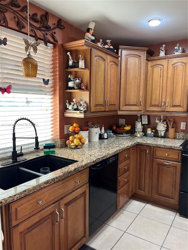 kitchen featuring light stone counters, dishwasher, light tile patterned flooring, and sink