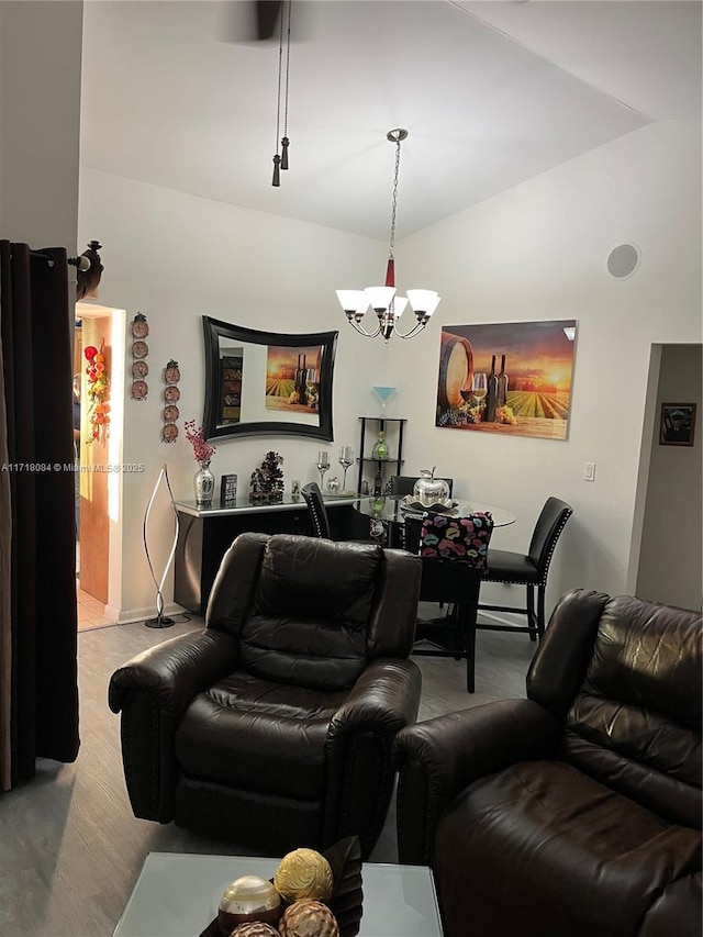 living room with vaulted ceiling and a notable chandelier