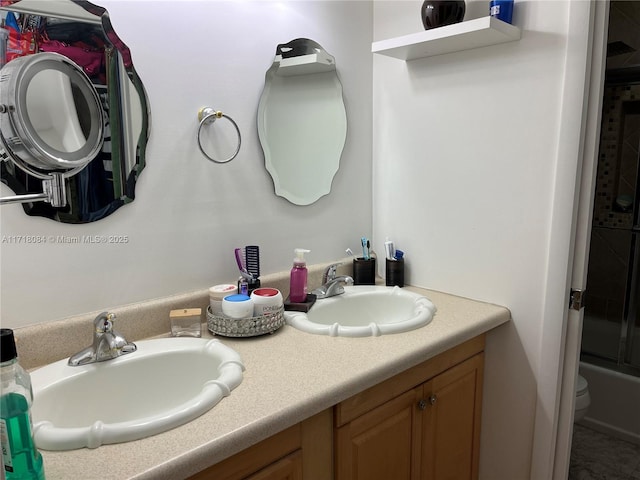 full bathroom with vanity, bath / shower combo with glass door, and toilet