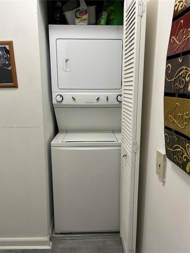 laundry room with stacked washer / dryer