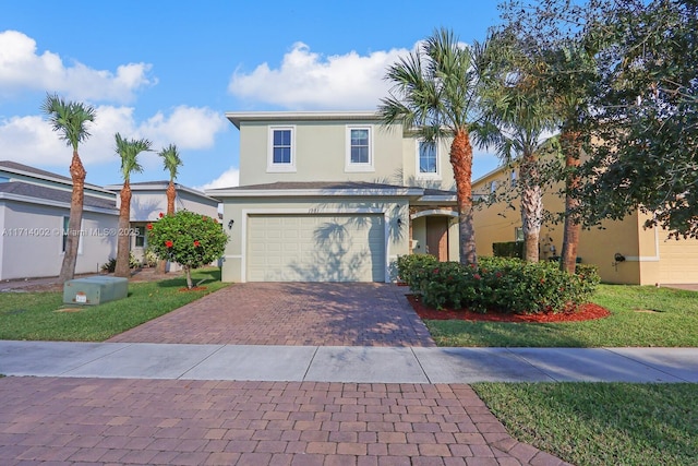 front facade featuring a front lawn and a garage