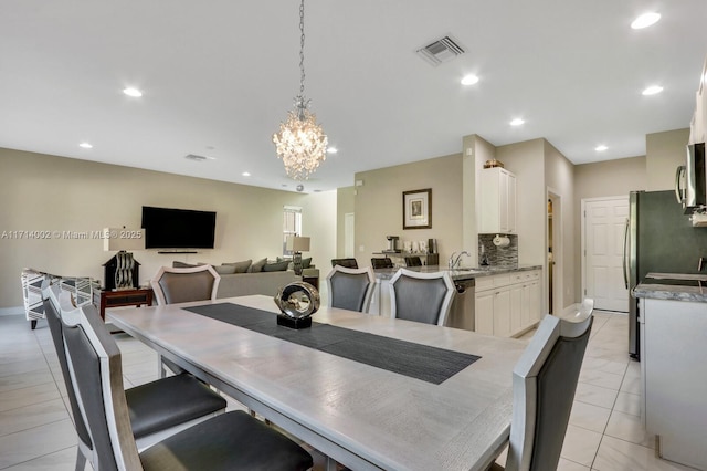 tiled dining room with a chandelier