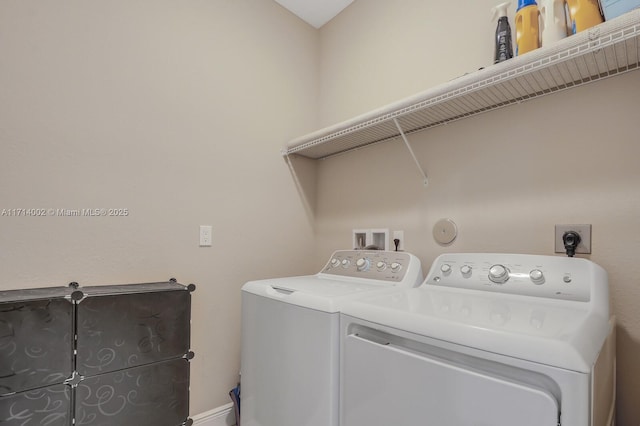 clothes washing area featuring separate washer and dryer