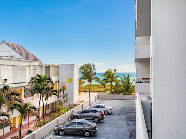 view of car parking featuring a water view