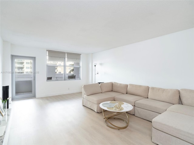 living area with wood finished floors and baseboards