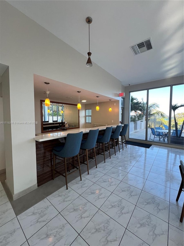 interior space featuring visible vents, high vaulted ceiling, and marble finish floor