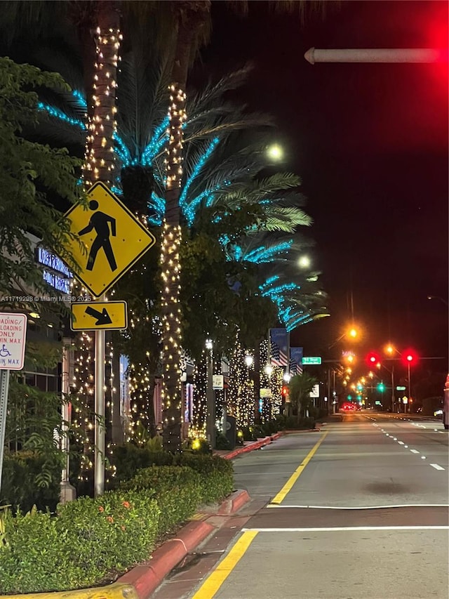 exterior space with traffic lights, curbs, and traffic signs