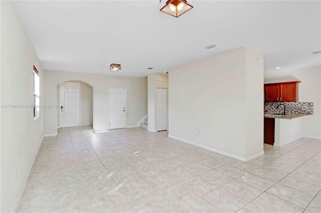 spare room with sink and light tile patterned floors