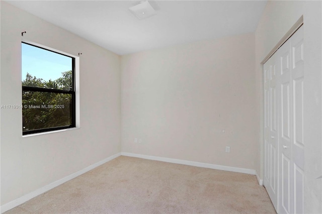 spare room with light colored carpet