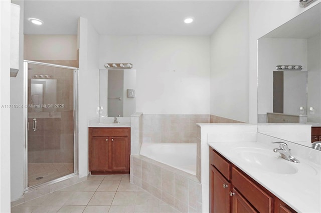 bathroom with tile patterned flooring, vanity, and plus walk in shower