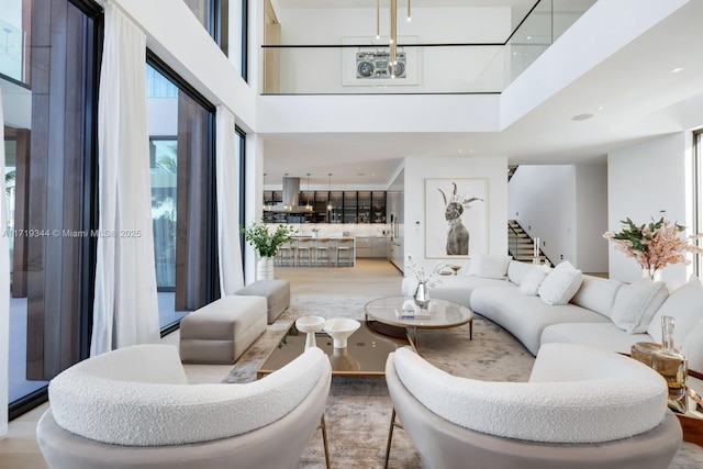 living room with a towering ceiling and wood-type flooring