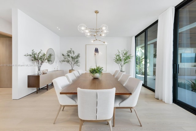 dining room featuring floor to ceiling windows, a chandelier, and light wood-type flooring