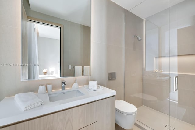 bathroom featuring an enclosed shower, vanity, toilet, and tile walls