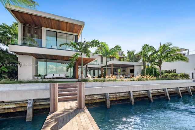 rear view of house featuring an outdoor hangout area and a water view