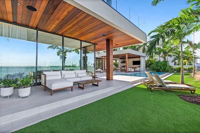 view of patio with an outdoor living space and a water view