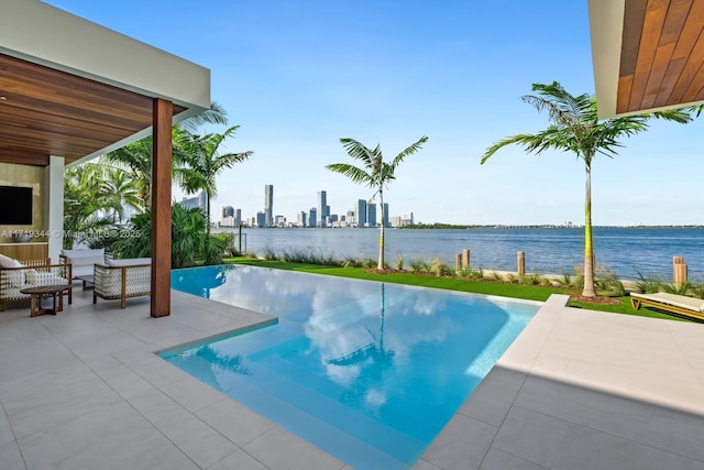 view of swimming pool with a patio and a water view