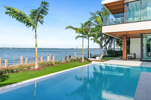 view of pool with a water view and a patio area