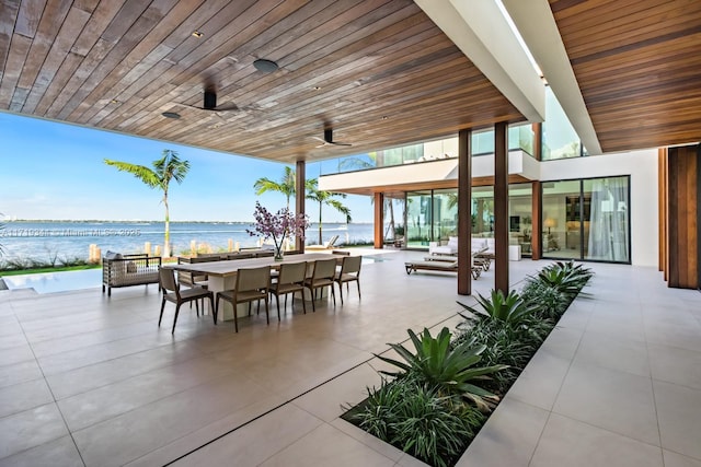 view of patio / terrace with ceiling fan and a water view