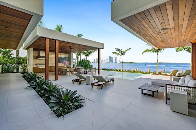 view of patio featuring an outdoor living space and a water view