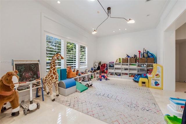 recreation room with tile patterned flooring and ornamental molding